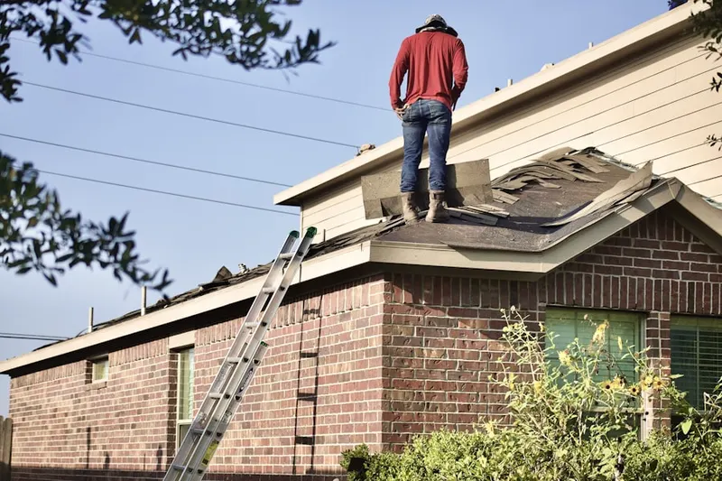 Professional roofer working on a residential roof in Lasley